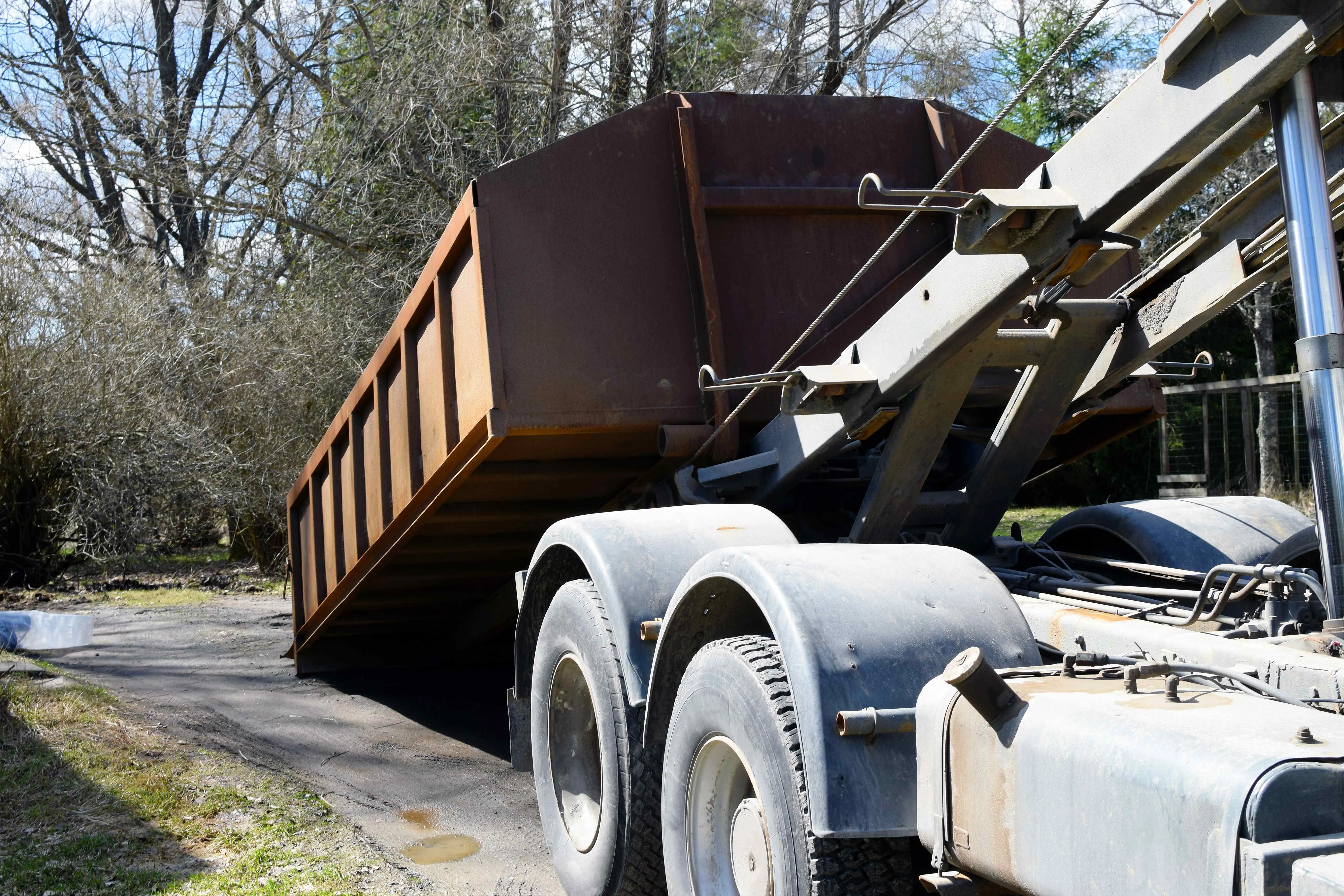 roll off truck delivering dumpster