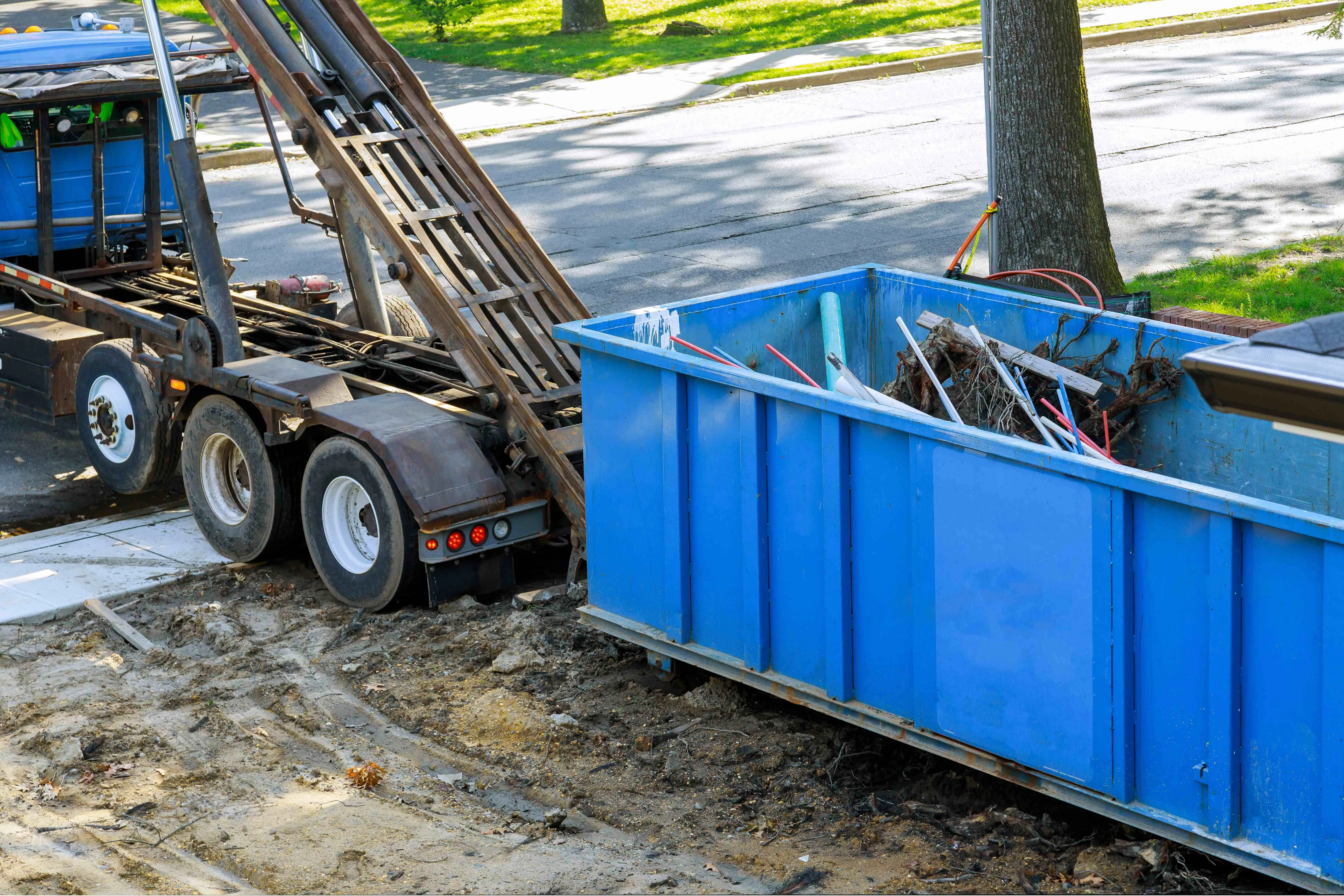 dumpster being picked up