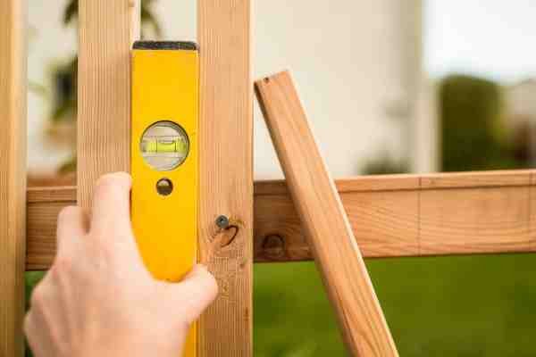 Attaching panels to posts for dumpster enclosure