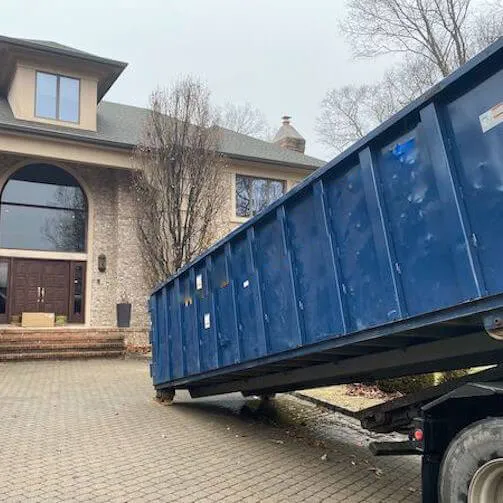 Image of medium dumpster being lowered onto property