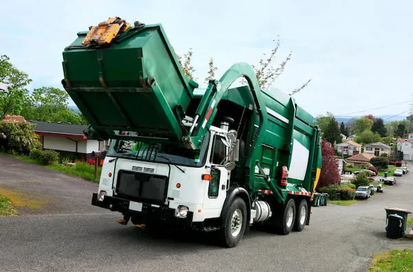 Front end garbage truck lifting dumpster