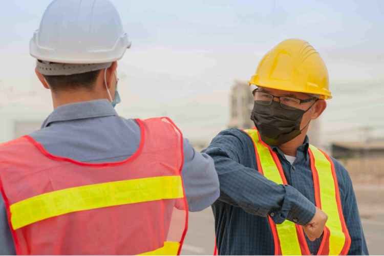 construction workers embracing