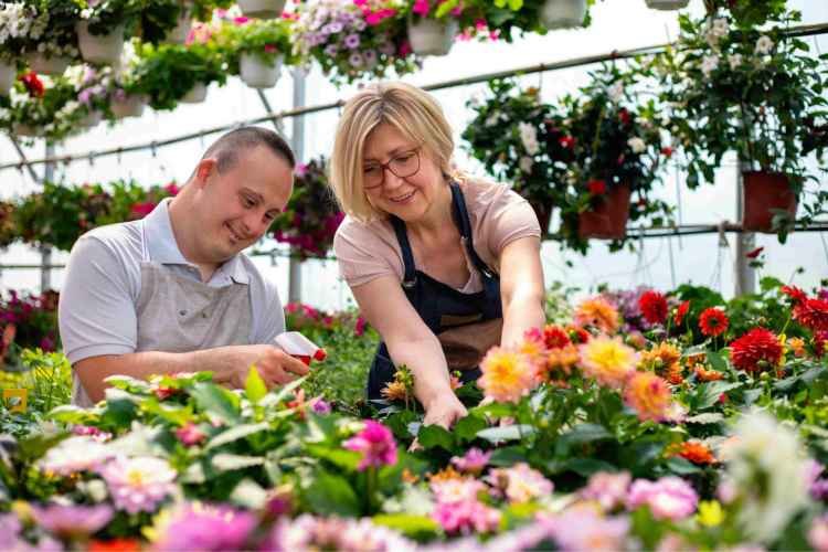 A man and a women at a gardening center donating dirt