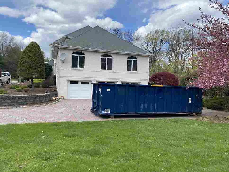 Picture of a dumpster in front of home garage