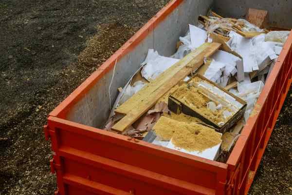 Red roll off dumpster filled with debris