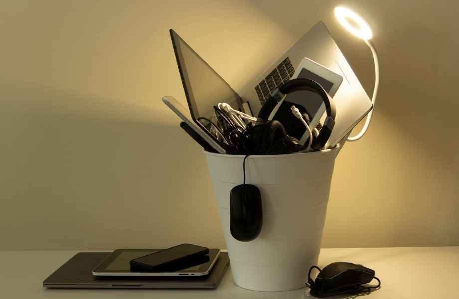 A picture of a trash bin filled with electronics 