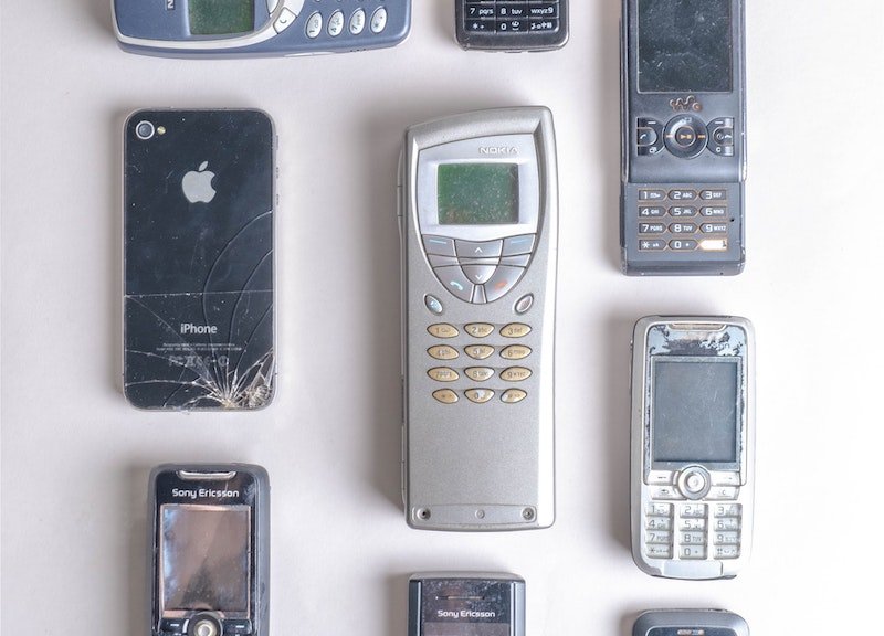 Old phones lined up that are now e-waste