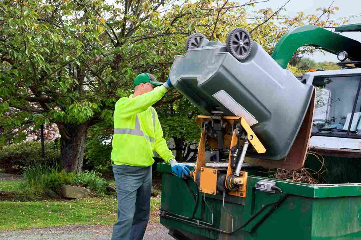 garbage man servicing toter