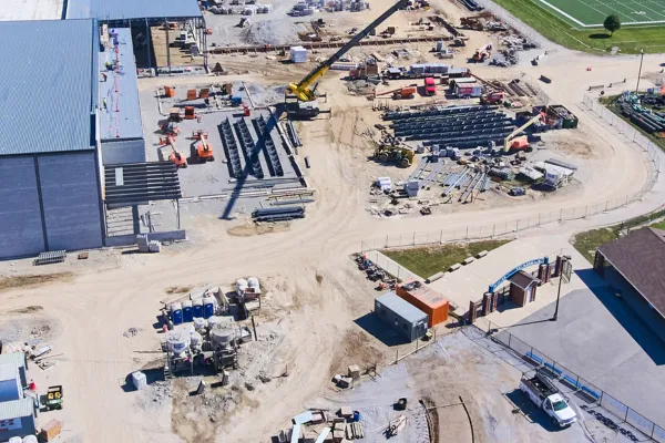 high school construction site with dumpsters, portable toilets and mobile offices