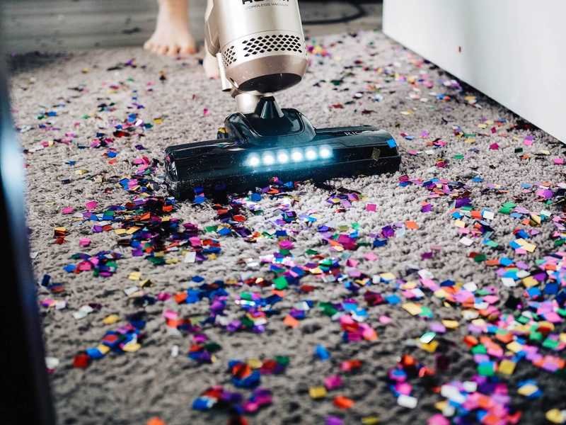 Vacuum cleaner vacuuming up confetti from New Years