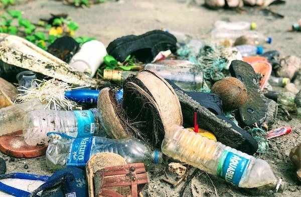 A pile of trash and recycling on the ground