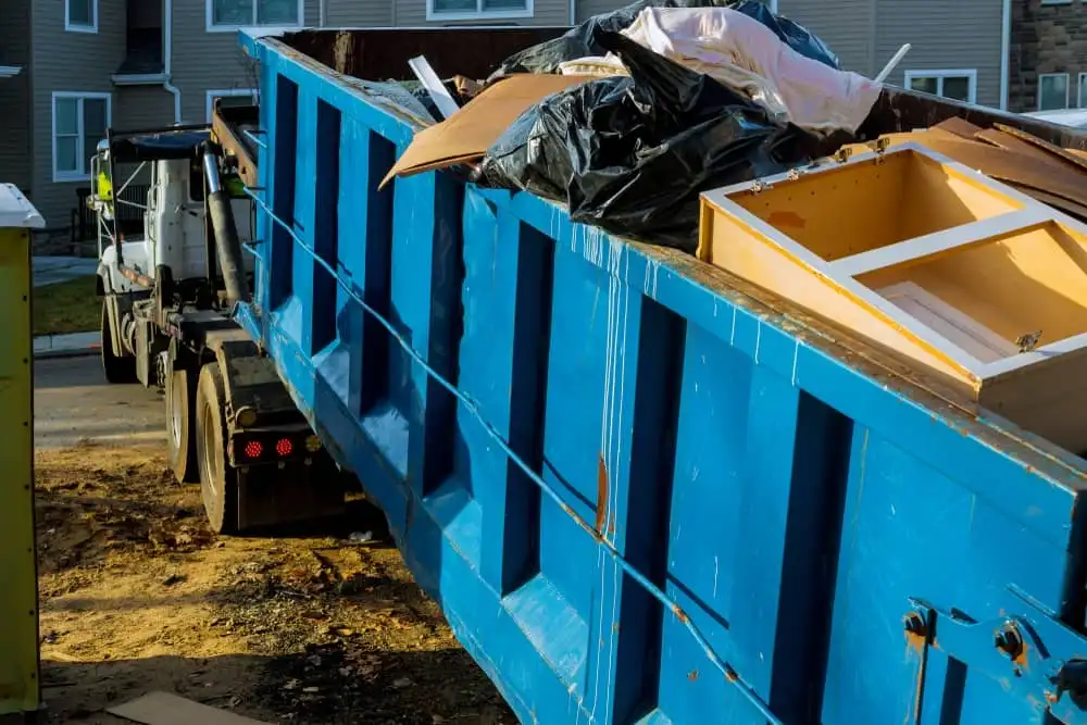 Blue dumpster attached to truck
