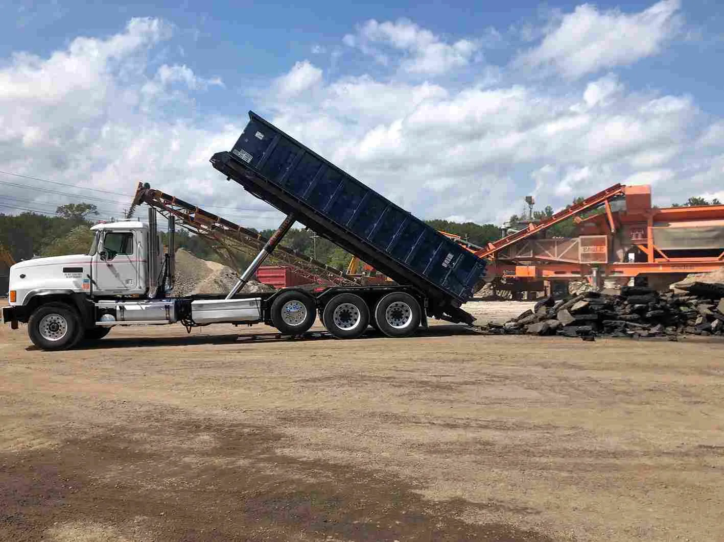 Image of truck offloading roll off bin
