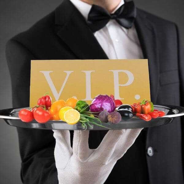 Waiter Holding a Tray with a VIP sign and vegetables on it